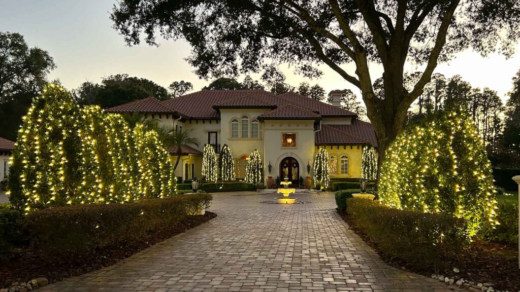 White Christmas Light Install on Mansion Landscape